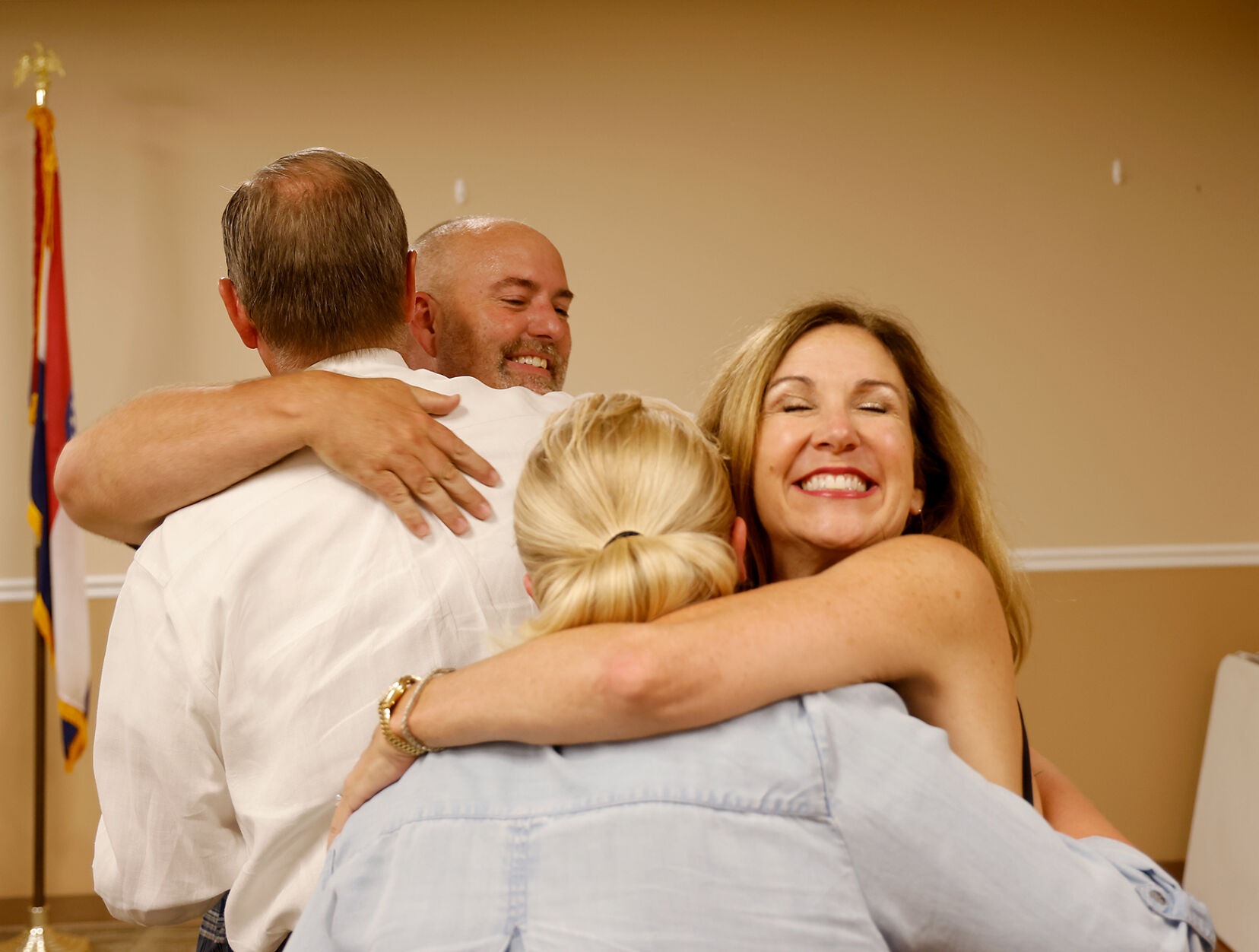 Former mayor Brian Treece, left, hugs Adrian Plank while Elisabeth Condon, (copy)